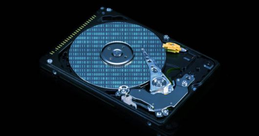 HDD. Open computer hard drive. Blue effect with dark background